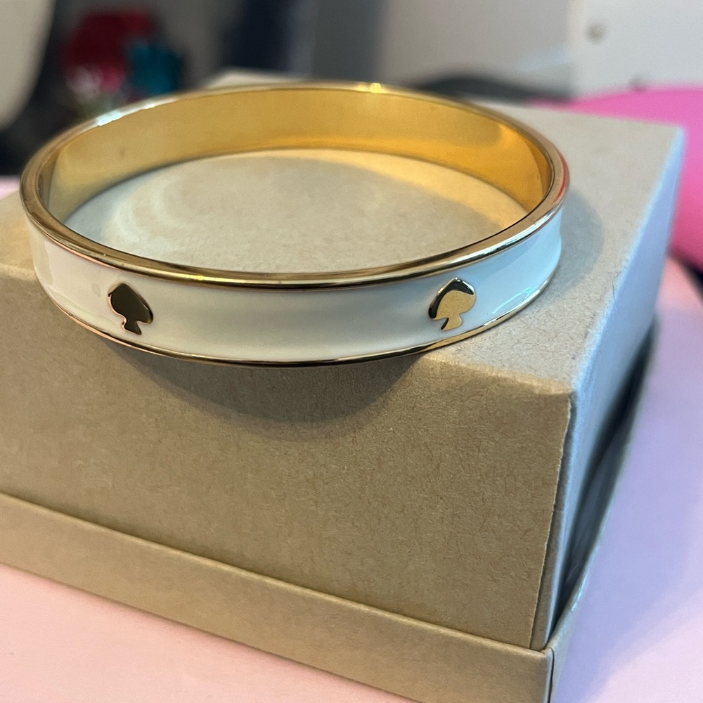 KATE SPADE like new ivory & gold bangle bracelet with 6 signature spade logos